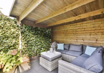 Patio seating area inside a timber garden room structure in Alvaston & Boulton