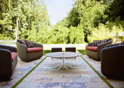 Multicolour sandstone patio seating area with natural stone paving in Aston On Trent