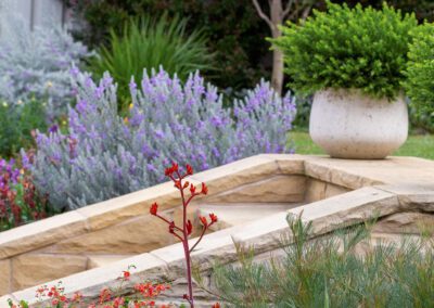 Sandstone formal garden steps with layered stone edging and planting in Beeston