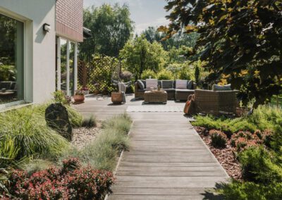 Landscaping in Melbourne featuring a spacious decking seating area with planting borders