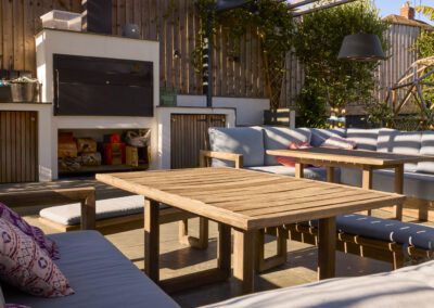 Outdoor kitchen with patio seating, pergola and privacy fencing in a Borrowash garden
