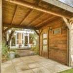 Landscaping in Breaston with a timber garden building and a paved seating area in a tidy, structured garden layout