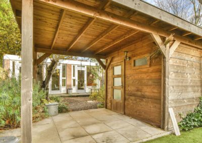 Landscaping in Breaston with a timber garden building and a paved seating area in a tidy, structured garden layout
