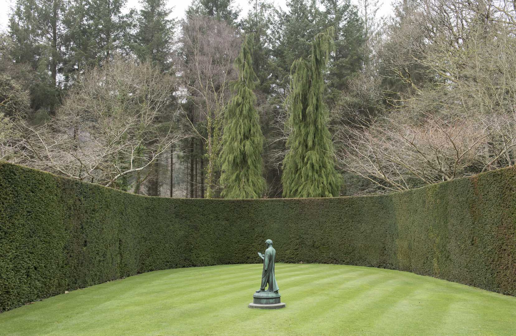 Garden maintenance in Duffield, keeping a formal lawn striped and hedge lines crisp around a feature statue.