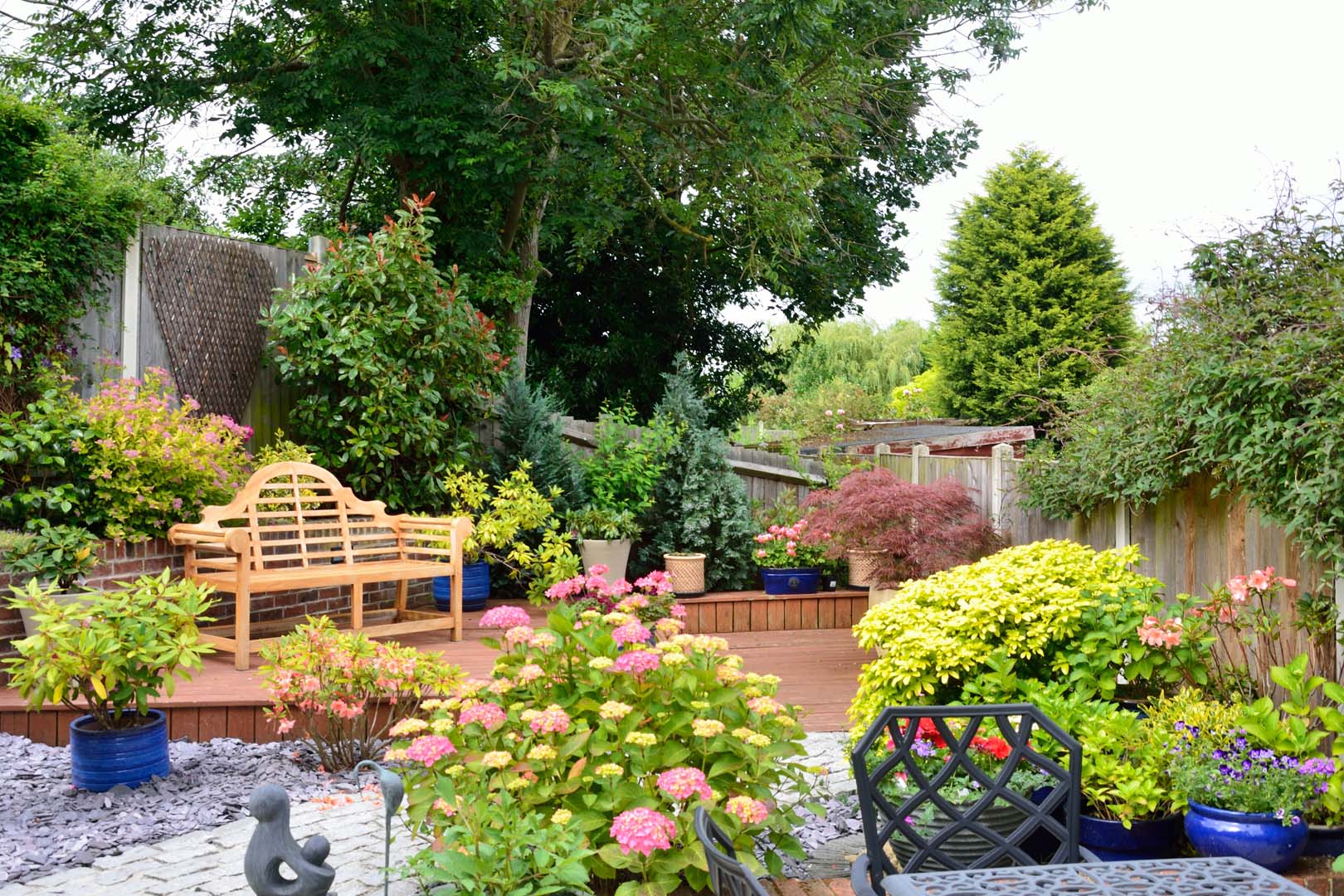 Garden maintenance in Stenson Fields with maintained borders, pruned shrubs and a tidy seating area